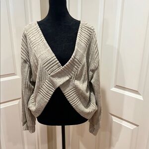 Woman’s, tan, v-neck, ribbed, crossover, sweater. Size large. Brand unknown.